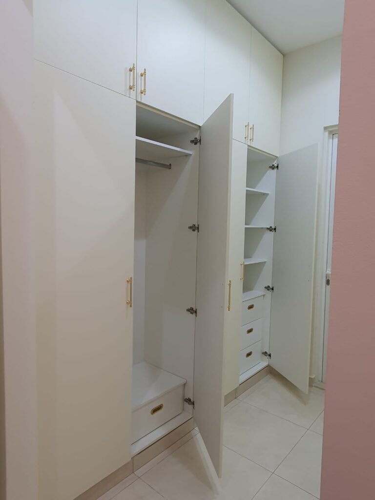 Custom Built-In Floor-to-Ceiling Matt White Wardrobe with Elegant Gold Handles.jpeg