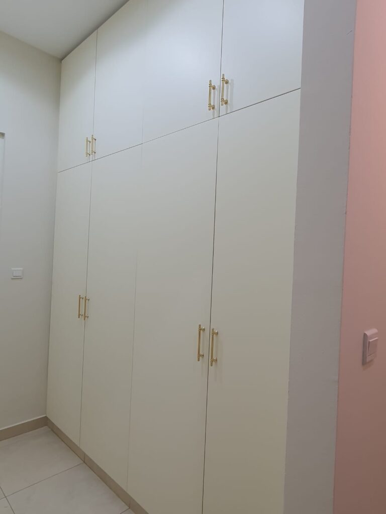Custom Built-In Floor-to-Ceiling Matt White Wardrobe with Elegant Gold Handles.jpeg