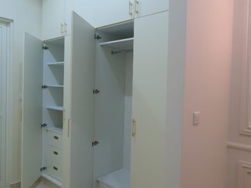 Custom Built-In Floor-to-Ceiling Matt White Wardrobe with Elegant Gold Handles.jpeg