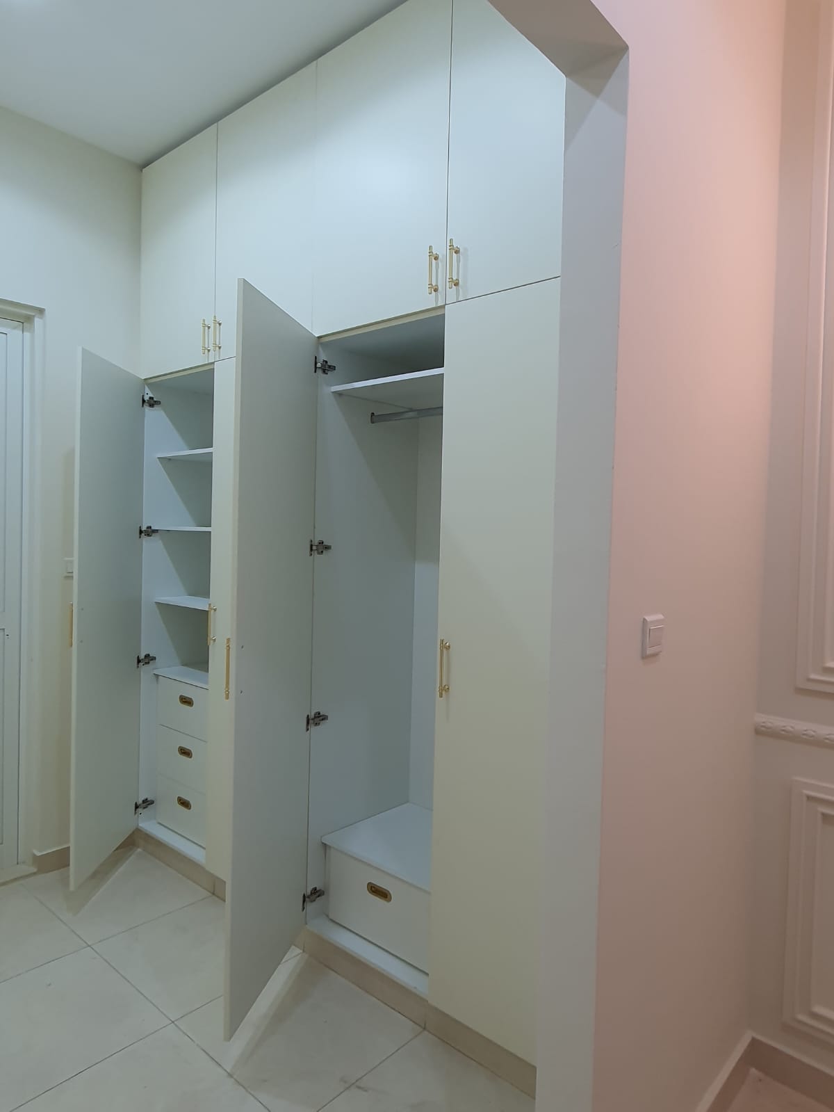Custom Built-In Floor-to-Ceiling Matt White Wardrobe with Elegant Gold Handles.jpeg