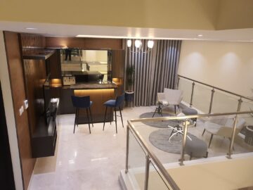 Luxury Mezzanine Home Bar with Fluted Wood Counter and Velvet Bar Stools